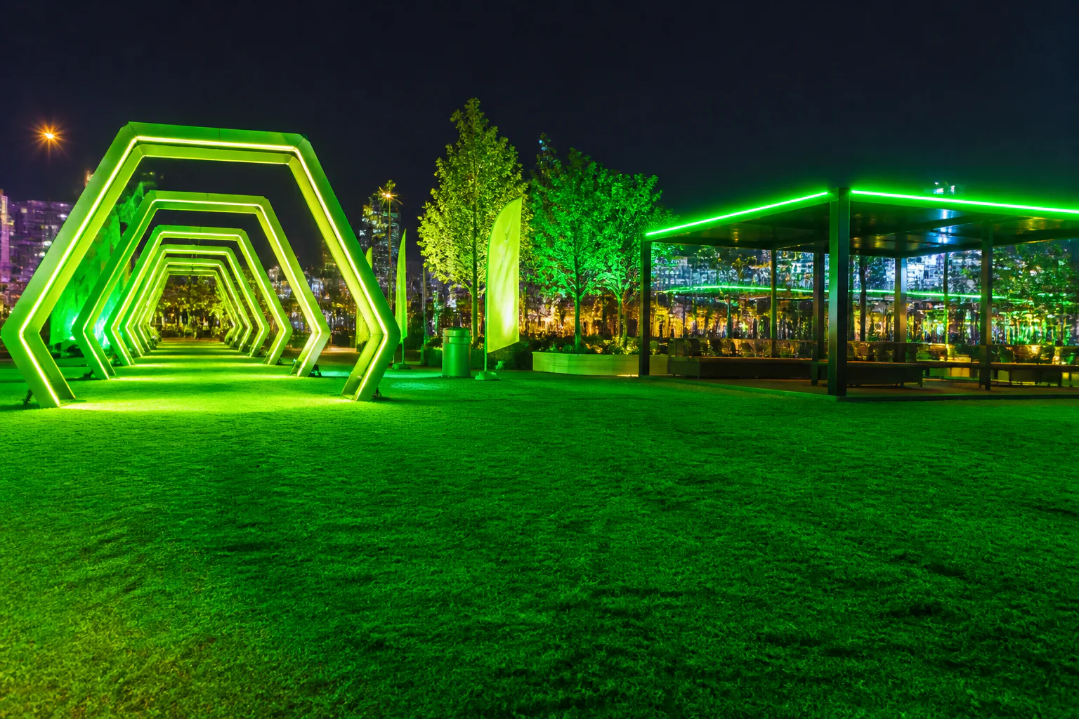Neon-lit hexagonal walkway at night