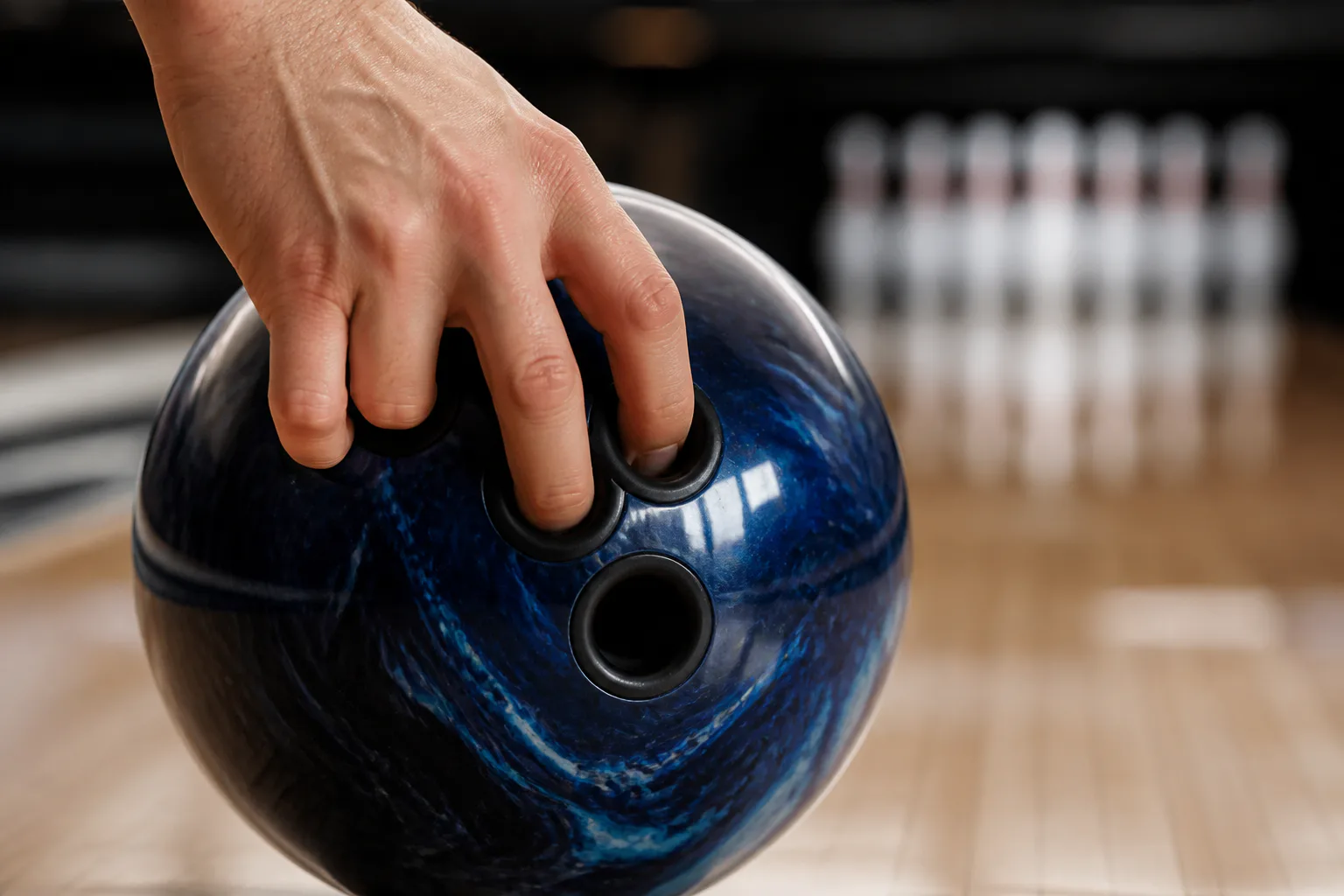 Hand gripping a bowling ball