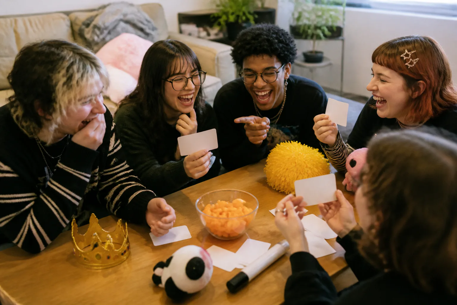 Friends laughing at a table game